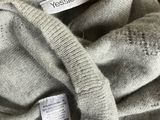 the label is on the sweater of a woman who is wearing a sweater