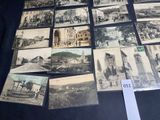 a lot of old postcards on display on a table