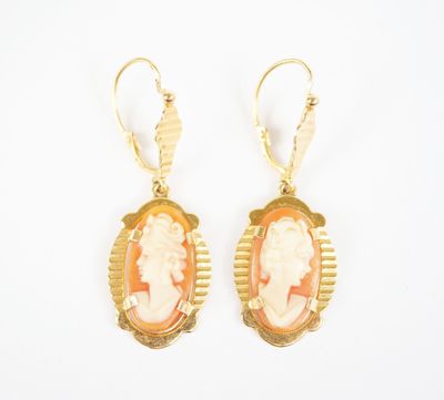 an image of a pair of earrings with a woman ' s profile