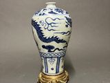 chinese blue and white porcelain vase with a dragon on a stand