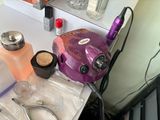 a purple hair dryer sitting on top of a table