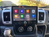 a close up of a car dashboard with an apple carpbook in the center
