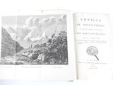 an open book with a picture of a mountain scene in it
