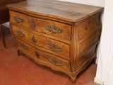 a wooden chest of drawers in the corner of a room