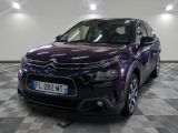 l'avant d'une Citroën violette garée sur un sol à damier