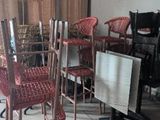 chairs and a table in a room with a large window