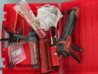 a red box with tools in it on a table