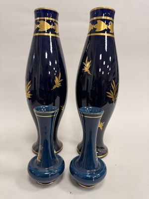 une paire de vases bleus et dorés sur fond blanc