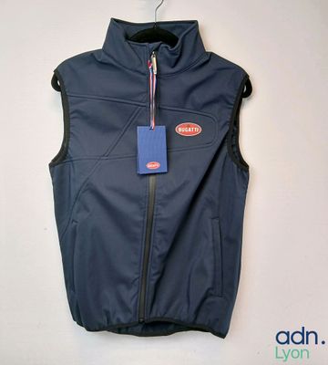 the vest is blue and has a tag on it