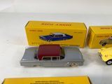 three toy cars are sitting next to each other on a table
