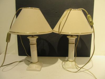 two lamps that are sitting on a white table