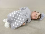 a baby doll that is laying down on the floor