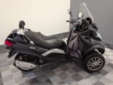 a motorcycle that is parked on a checkered floor
