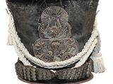 a black pot with a silver decoration on it
