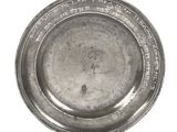une assiette en argent comportant une inscription sur un fond blanc