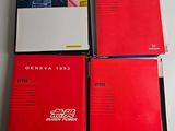 four red books sitting on top of each other on a table