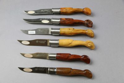 six different types of knives are lined up on a table