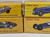 three boxed toy cars sitting on top of each other on a table