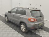 a picture of a silver volkswagen suv parked in a garage