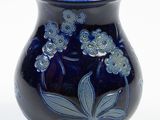 a blue vase with flowers on it on a white background