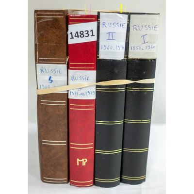 three books are stacked on top of each other on a white surface