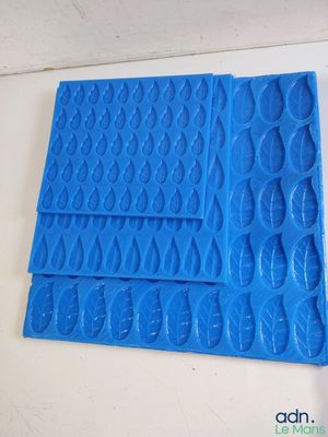 a close up of a piece of blue plastic on a table