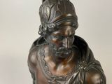 statue of a bust of a man with a bird on top of his head