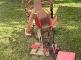 a red object sitting in the grass next to a red box