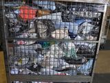 a metal cage filled with lots of trash in a warehouse