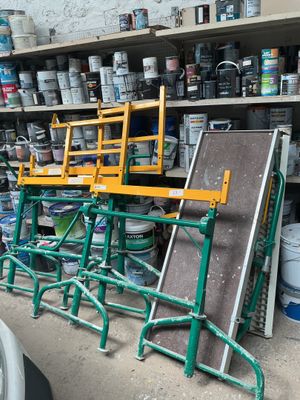 many cans of paint on the shelves in the garage
