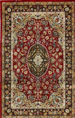 a red and black rug with a medallion design on it