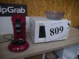 a microwave and a bowl on a table with a price tag
