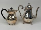 silver plated coffee pot and creamer on stand on white background