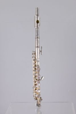 a flute that is sitting on top of a glass table