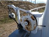 a rusted metal reel attached to the side of a white truck