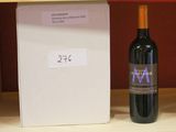 a bottle of wine sitting on a shelf next to a box