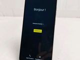 the back of a black samsung phone with a yellow sticker on it