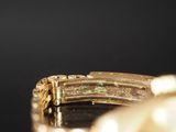 an image of a close up of a watch on a table