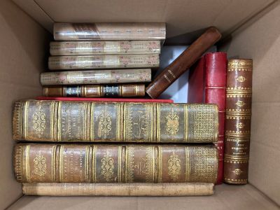 a box full of old books sitting on top of each other