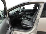 the interior of a car with the door open and the driver ' s seat down