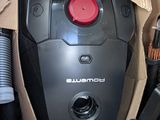 a black and red vacuum in a cardboard box