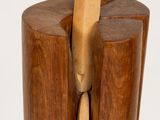 wooden sculpture of a person holding a wooden spoon in their hand