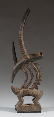 an image of a sculpture of a bird and a fish on a stand
