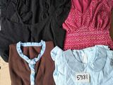 three women ' s shirts are in a box with a price tag