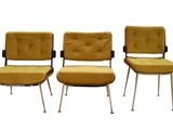 three yellow chairs sitting next to each other on a white surface