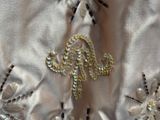 a close up of a dress with beads and beads on it