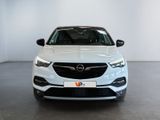 the front view of a white opel parked in a showroom