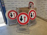 several red and white signs sitting on top of a metal stand
