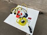 a yellow hose and a black cord on the ground
