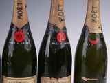 three bottles of champagne sitting next to each other on a table